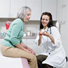 Photograph of a female doctor discussing medication with a female patient