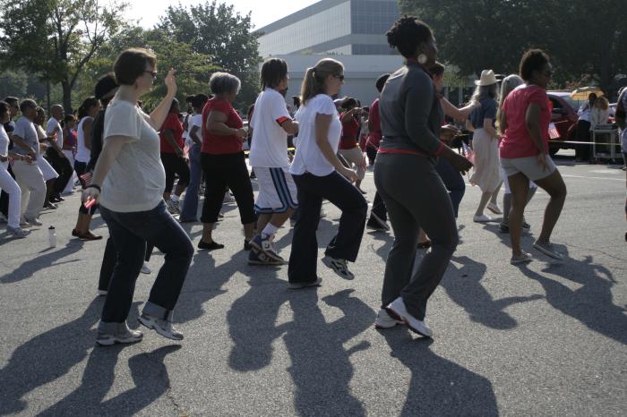 A large group of adults exercising outside