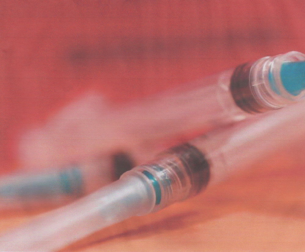 Three capped syringes